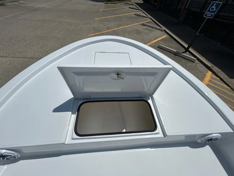 Slide: The Image of 2025 Shallow Sport 24 Sport boat with open storage compartment on deck. - 13