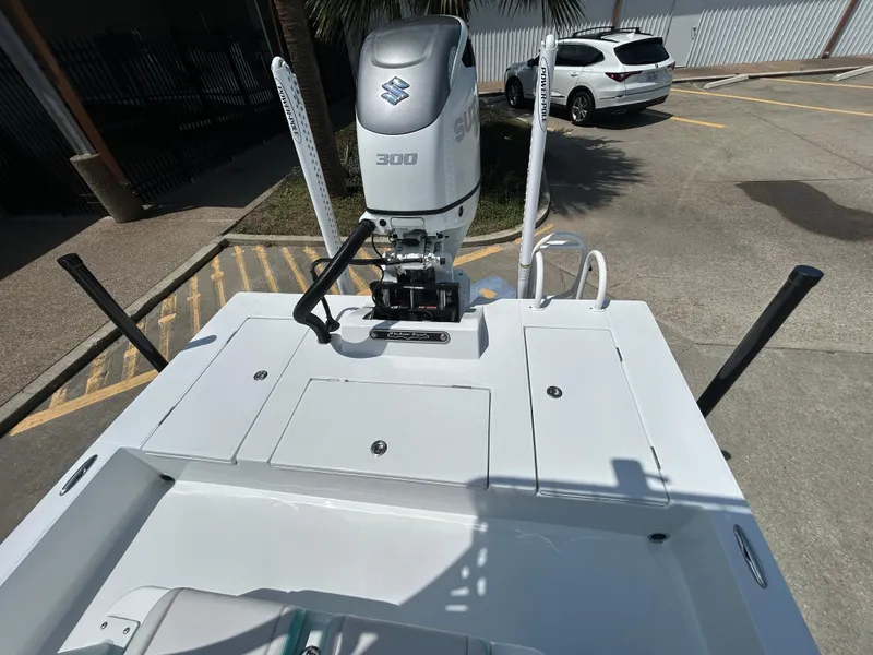 Slide: The Image of 2025 Shallow Sport 24 Sport boat with Suzuki 300 engine in a parking lot. - 16