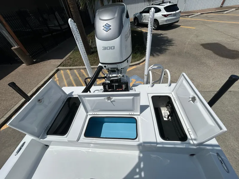 Slide: The Image of 2025 Shallow Sport 24 Sport boat with Suzuki 300 engine and open storage compartments. - 17