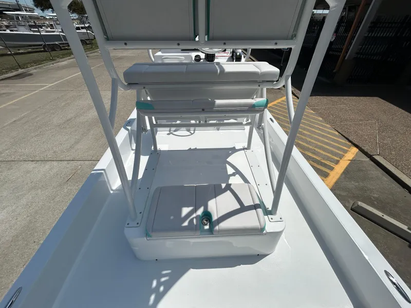 Slide: The Image of 2025 Shallow Sport 24 Sport boat interior with seating and storage compartments. - 19