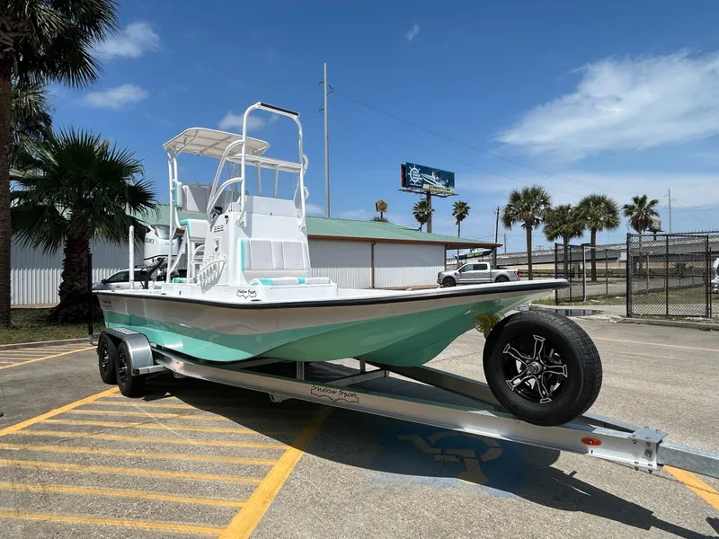 Slide: The Image of 2025 Shallow Sport 24 Sport boat on trailer, parked outdoors under clear sky. - 3