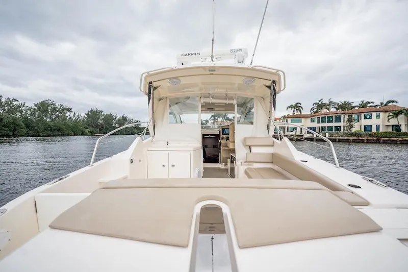 Slide: The Image of 2015 Pursuit SC 365i Sport Coupe on water, showcasing spacious deck and sleek design. - 24