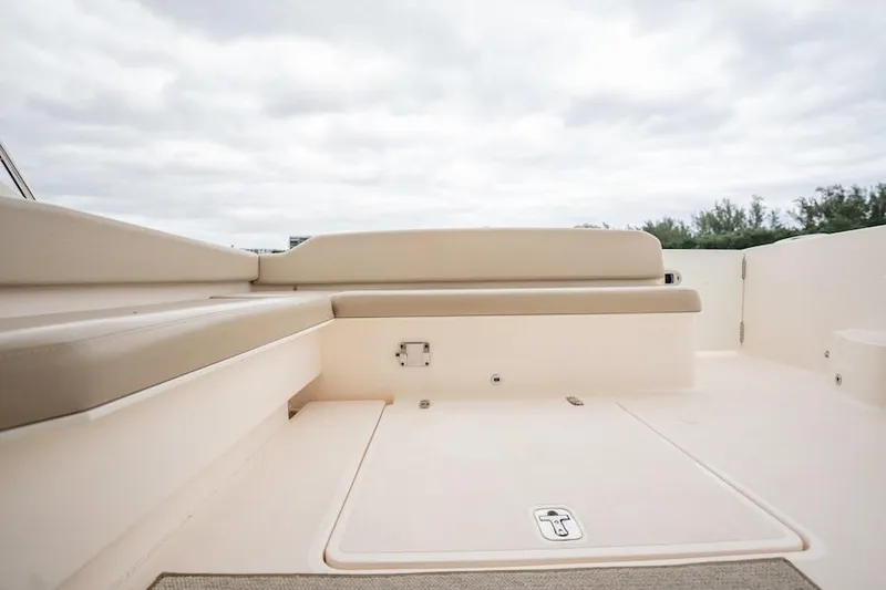 Slide: The Image of 2015 Pursuit SC 365i Sport Coupe deck with seating, under cloudy sky. - 28