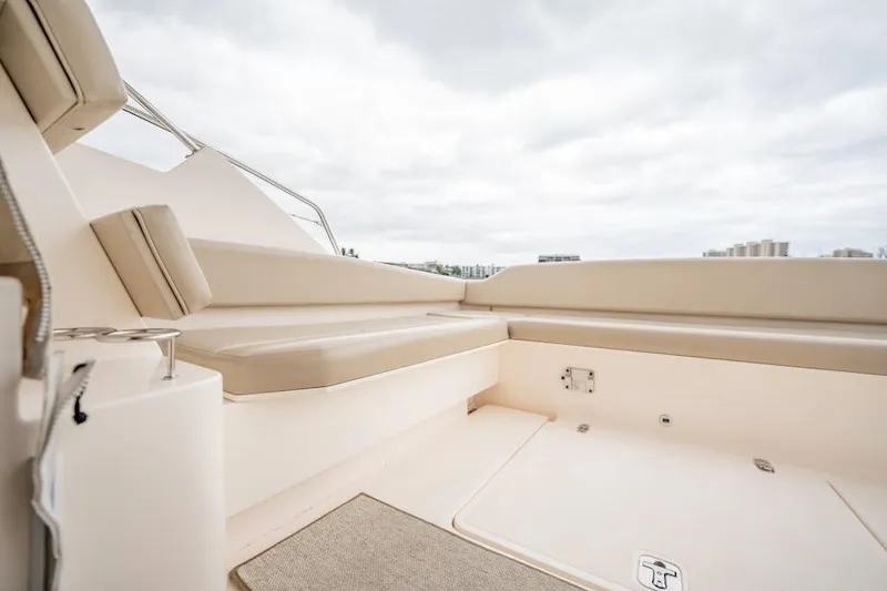 Slide: The Image of 2015 Pursuit SC 365i Sport Coupe interior with beige seating and cloudy sky. - 29