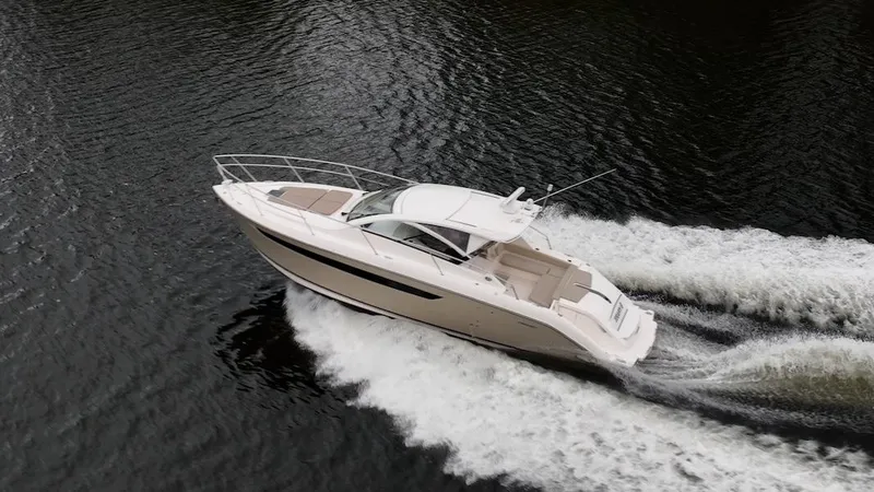 Slide: The Image of 2015 Pursuit SC 365i Sport Coupe cruising on water, aerial view. - 3