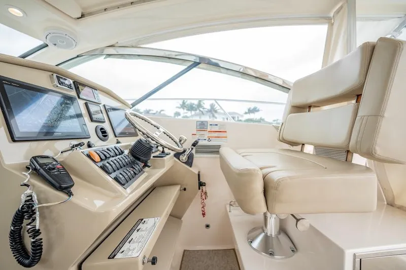 Slide: The Image of Helm of 2015 Pursuit SC 365i Sport Coupe with modern controls and seating. - 33