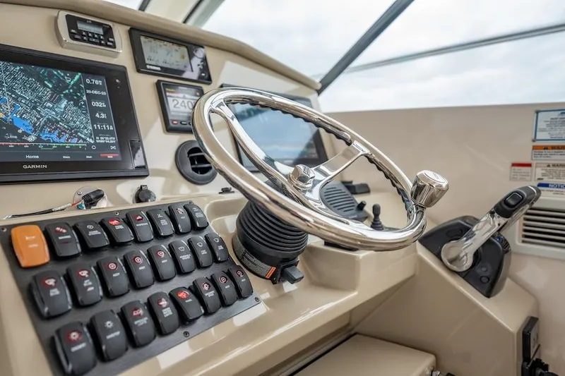 Slide: The Image of Helm of 2015 Pursuit SC 365i Sport Coupe with navigation controls and steering wheel. - 34