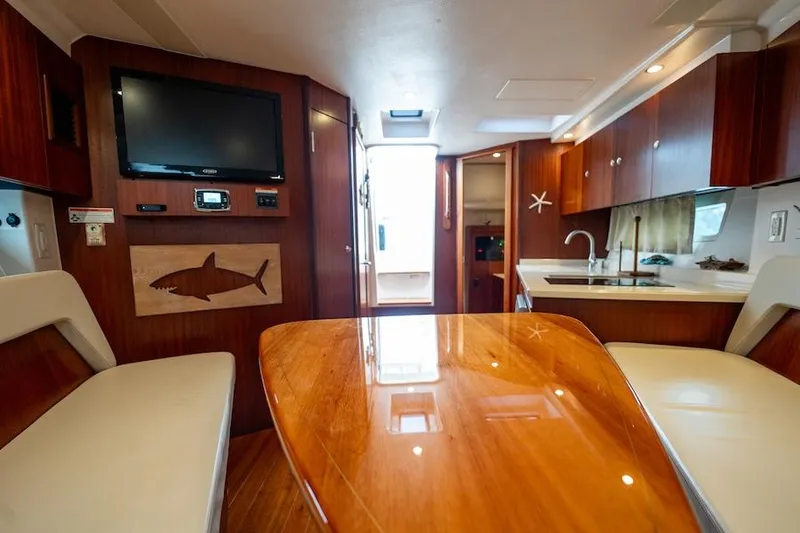 Slide: The Image of Luxurious interior of a 2015 Pursuit SC 365i Sport Coupe with wood finishes and modern amenities. - 36