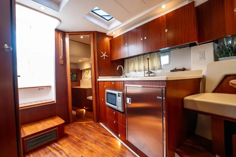 Slide: The Image of Luxurious interior of 2015 Pursuit SC 365i Sport Coupe with modern kitchen amenities. - 38