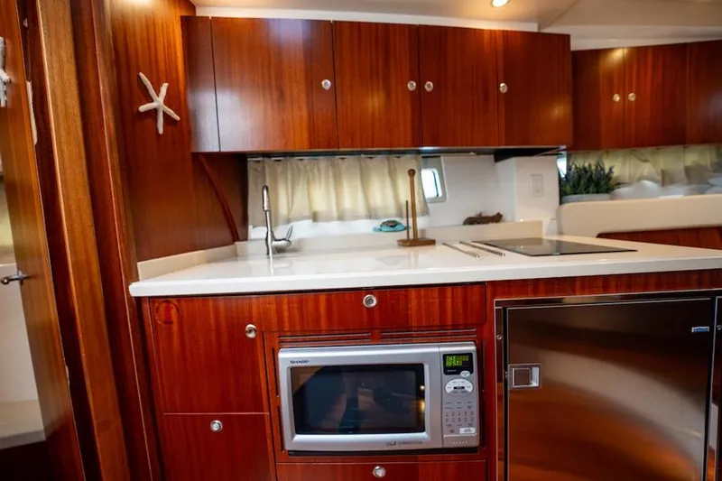 Slide: The Image of Luxurious 2015 Pursuit SC 365i Sport Coupe kitchen with wood cabinets and modern appliances. - 39