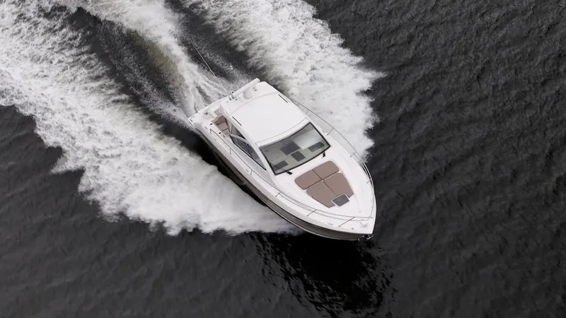 Slide: The Image of 2015 Pursuit SC 365i Sport Coupe cruising on open water, aerial view. - 4