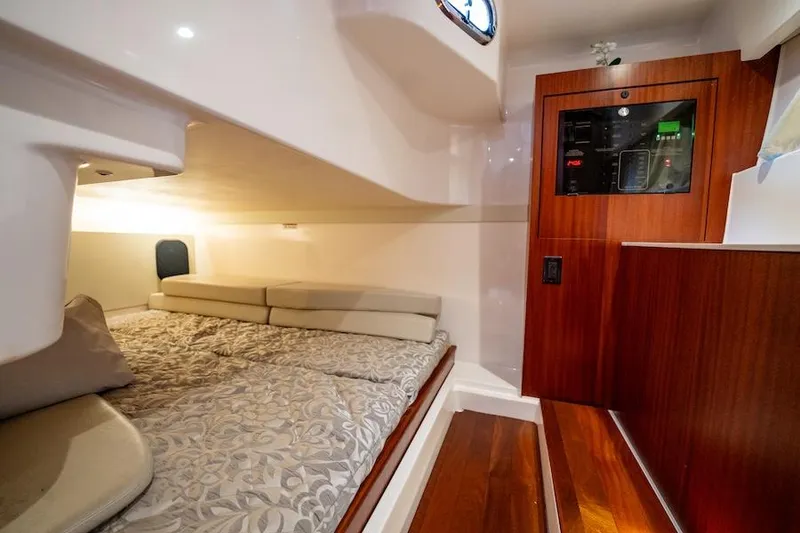 Slide: The Image of 2015 Pursuit SC 365i Sport Coupe cabin with bed and wooden paneling. - 41