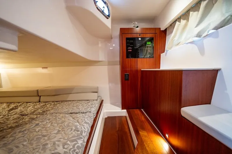 Slide: The Image of 2015 Pursuit SC 365i Sport Coupe interior with bed, wood paneling, and modern design. - 42