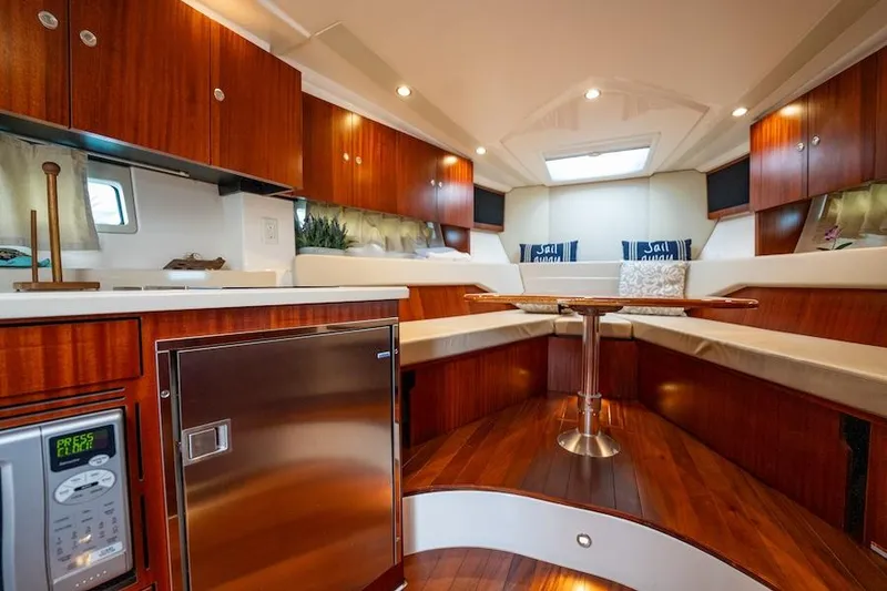 Slide: The Image of Luxurious interior of 2015 Pursuit SC 365i Sport Coupe with wood finishes and modern amenities. - 45