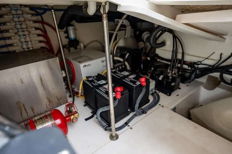 Slide: The Image of Engine room of 2015 Pursuit SC 365i Sport Coupe with batteries and fire extinguisher. - 46