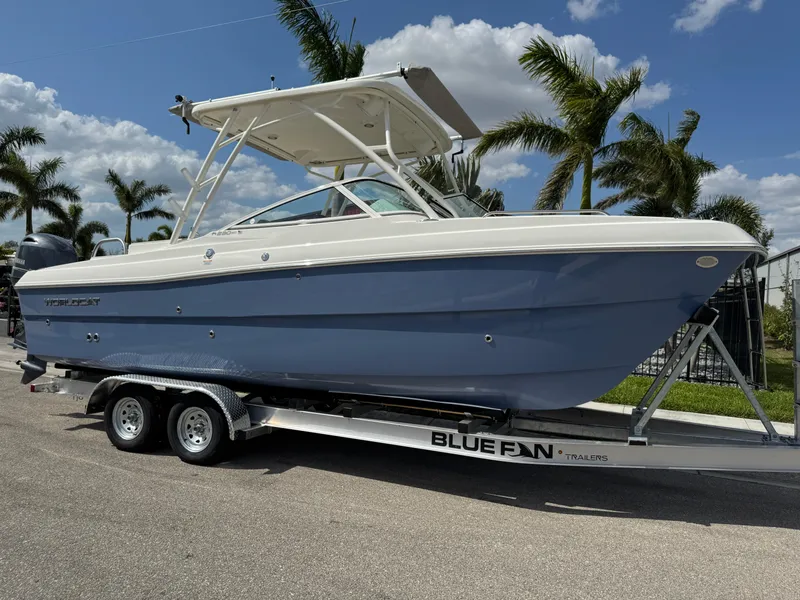 Slide: The Image of 2022 World Cat 230 SD boat on trailer, palm trees in background, sunny day. - 1