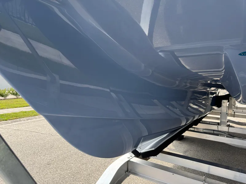 Slide: The Image of 2022 World Cat 230 SD boat hull on trailer, showcasing sleek design and glossy finish. - 12