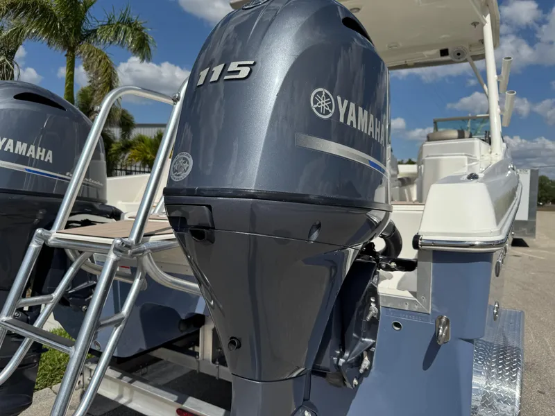 Slide: The Image of 2022 World Cat 230 SD boat with Yamaha 115 outboard motor, ladder, and clear sky background. - 20