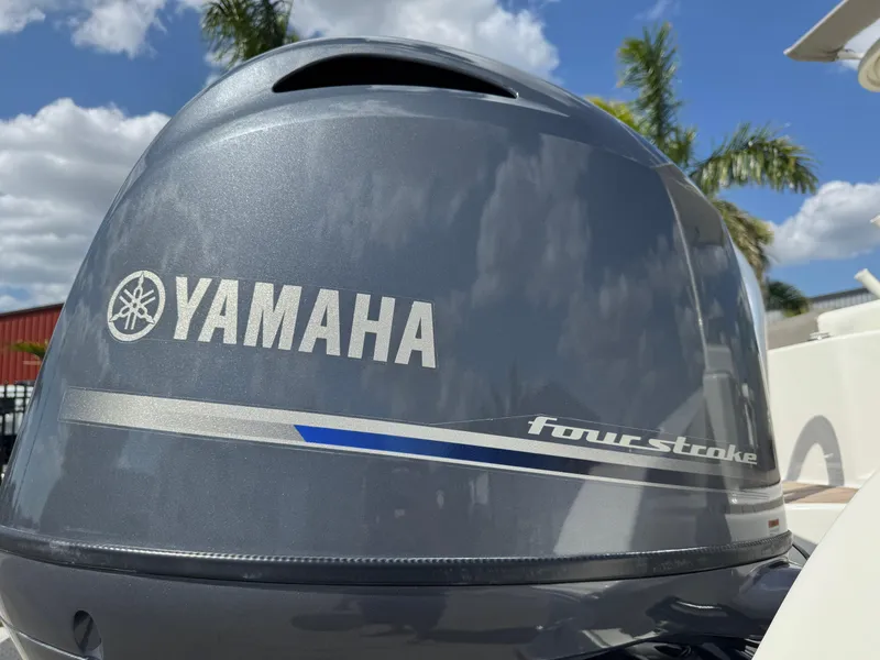 Slide: The Image of Yamaha four-stroke engine on 2022 World Cat 230 SD, with palm trees and blue sky background. - 21