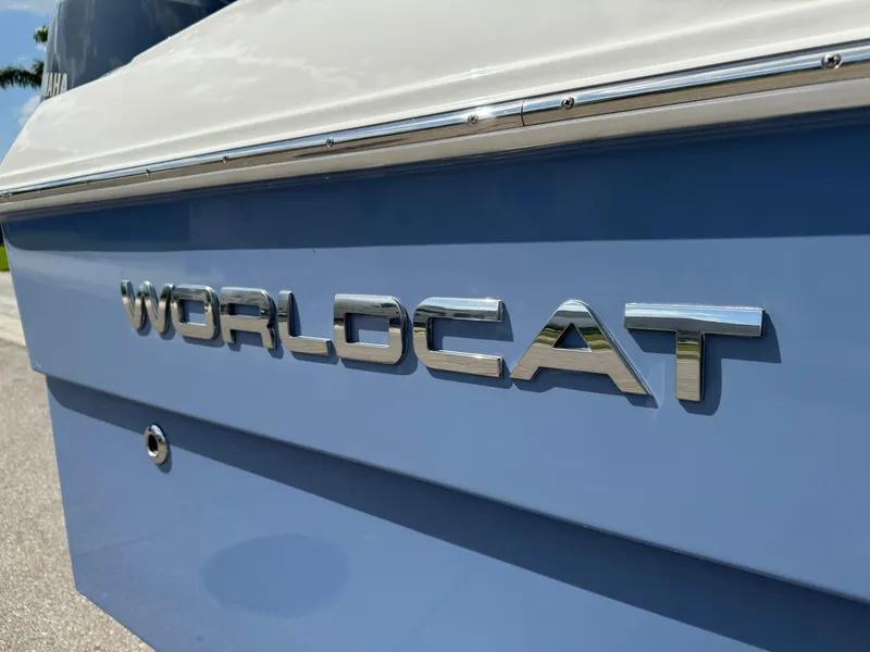 Slide: The Image of 2022 World Cat 230 SD boat, close-up of logo on blue hull. - 22