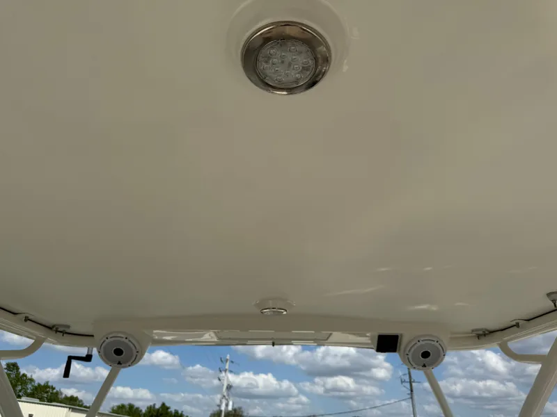 Slide: The Image of T-top view of 2022 World Cat 230 SD boat under a clear sky. - 29