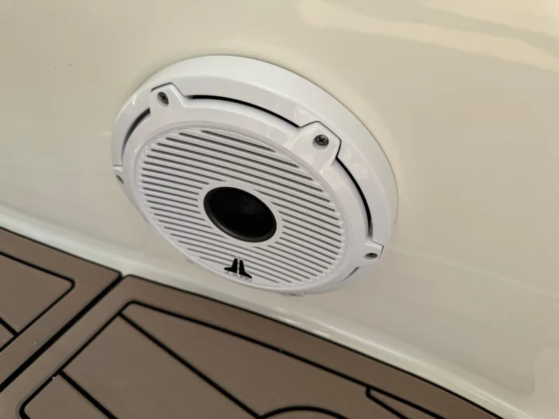 Slide: The Image of White speaker on 2022 World Cat 230 SD boat, mounted on beige deck. - 33