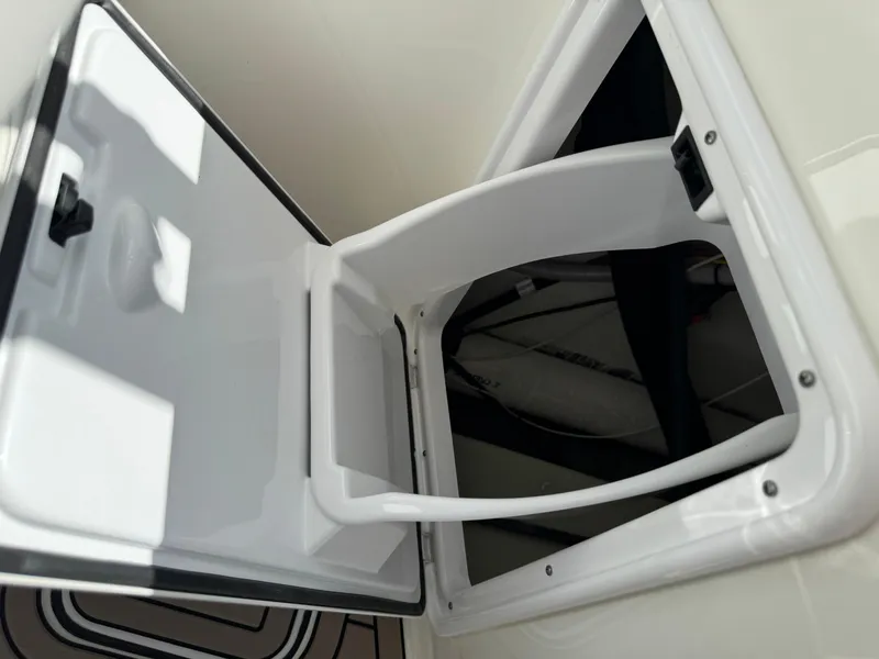 Slide: The Image of 2022 World Cat 230 SD boat storage compartment with open hatch. - 34
