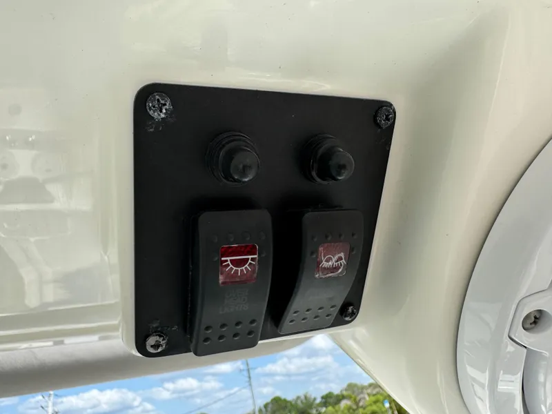 Slide: The Image of Control panel on a 2022 World Cat 230 SD boat with switches. - 36