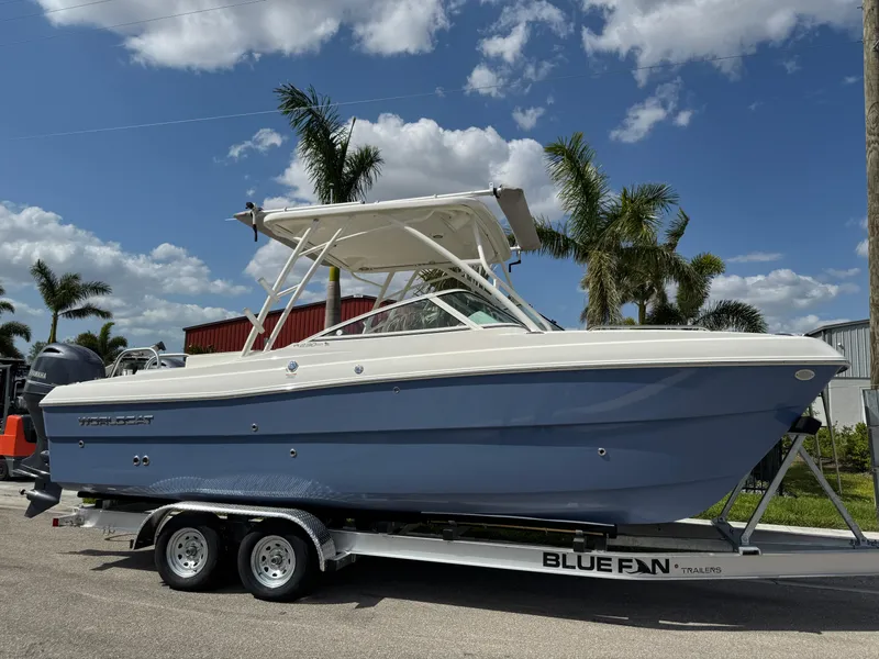 Slide: The Image of 2022 World Cat 230 SD boat on trailer, palm trees in background, clear sky. - 4
