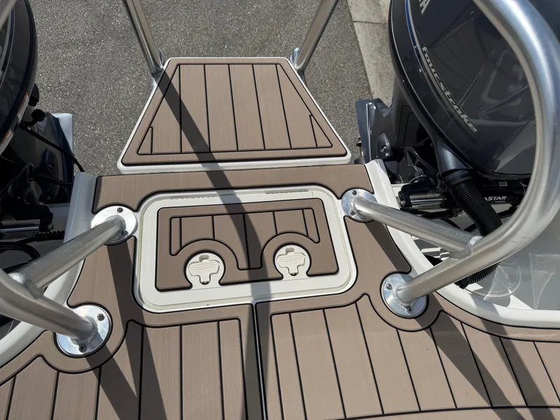 Slide: The Image of 2022 World Cat 230 SD boat deck with dual engines and stainless steel railings. - 42