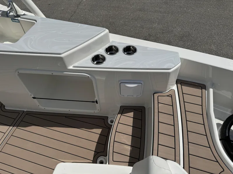 Slide: The Image of 2022 World Cat 230 SD boat interior with cup holders and teak flooring. - 43