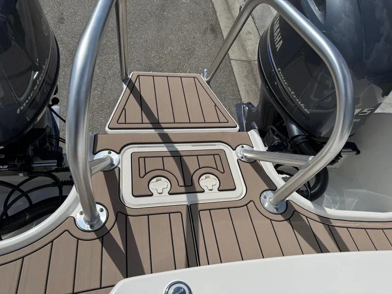 Slide: The Image of 2022 World Cat 230 SD boat deck with dual Yamaha engines and stainless steel railings. - 44