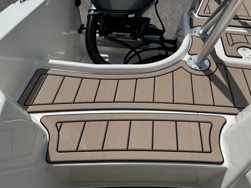Slide: The Image of 2022 World Cat 230 SD boat deck with tan non-slip flooring and stainless steel fixtures. - 48