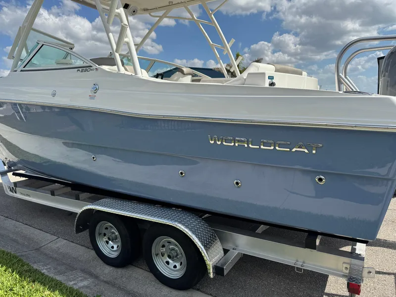 Slide: The Image of 2022 World Cat 230 SD boat on trailer under blue sky. - 5