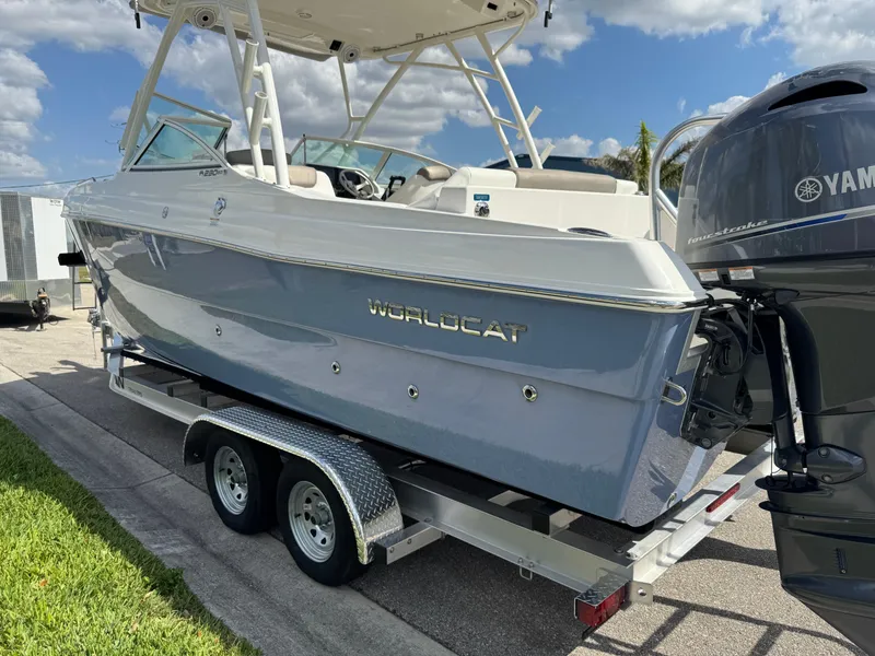 Slide: The Image of 2022 World Cat 230 SD boat on trailer, featuring Yamaha outboard motor, under a clear blue sky. - 8