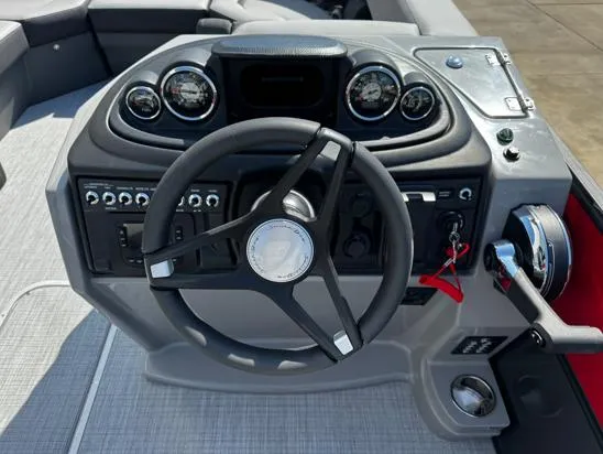 Slide: The Image of Steering console of 2025 South Bay S224UL boat with gauges and controls. - 4