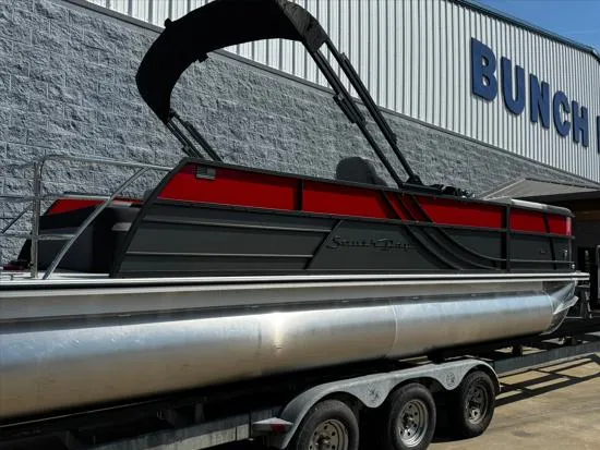 Slide: The Image of 2025 South Bay S224UL pontoon boat with red and black design on a trailer. - 9