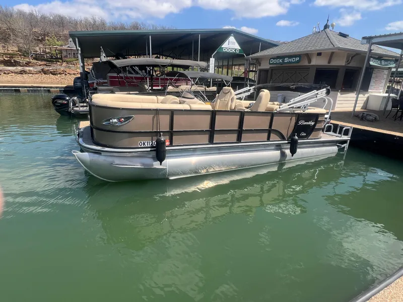Slide: The Image of 2019 Bentley Pontoons 223 docked at a marina under a clear blue sky. - 1