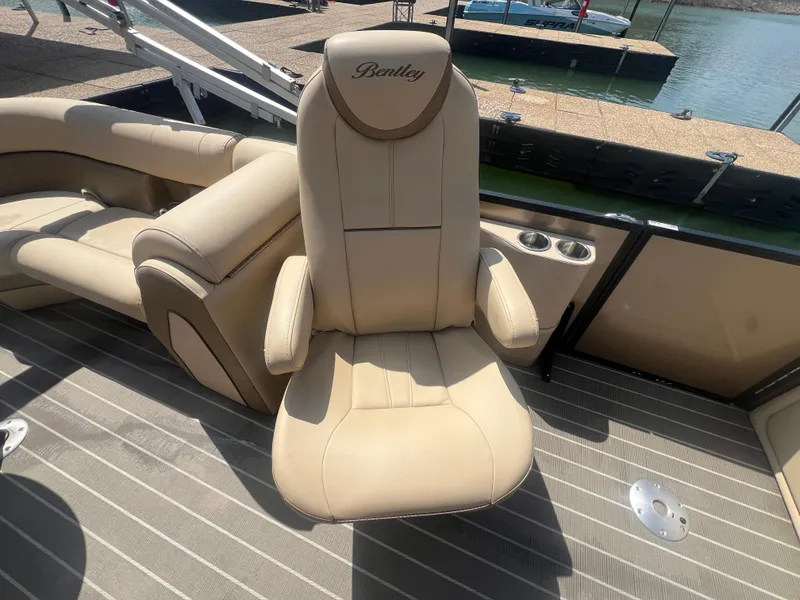 Slide: The Image of 2019 Bentley Pontoons 223 with beige captain's chair on deck. - 13