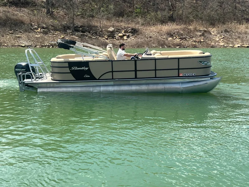 Slide: The Image of 2019 Bentley Pontoons 223 on a lake with a Mercury outboard motor. - 14