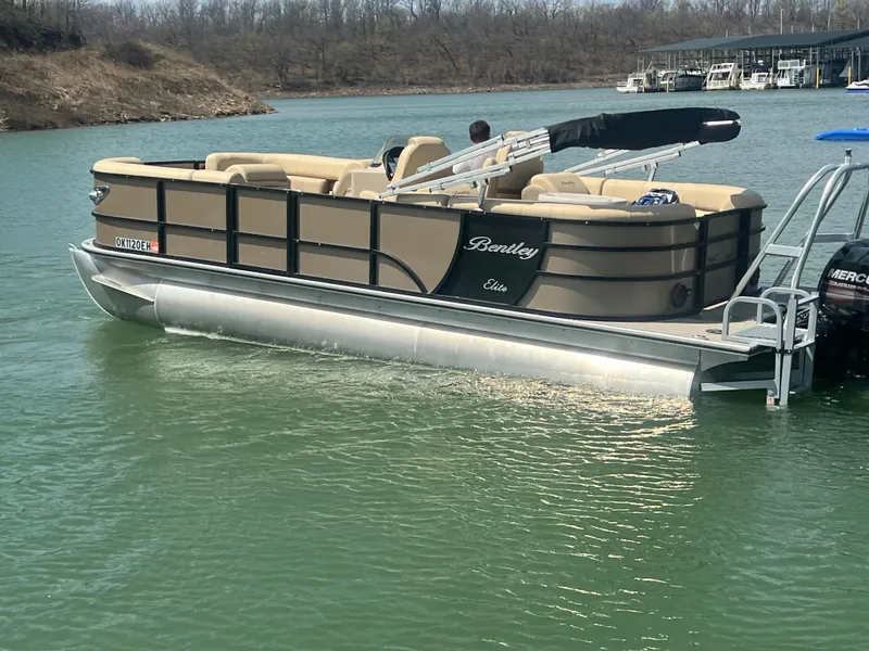 Slide: The Image of 2019 Bentley Pontoons 223 on a lake, featuring beige seating and sleek design. - 16