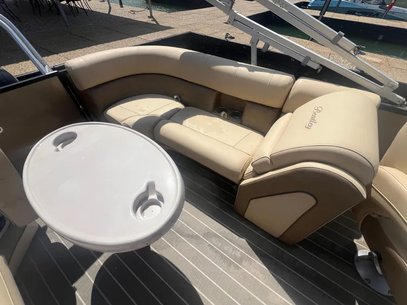 Slide: The Image of 2019 Bentley Pontoons 223 interior with beige seating and round table. - 19