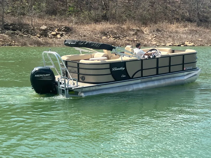 Slide: The Image of 2019 Bentley Pontoons 223 on a lake with Mercury outboard motor. - 20