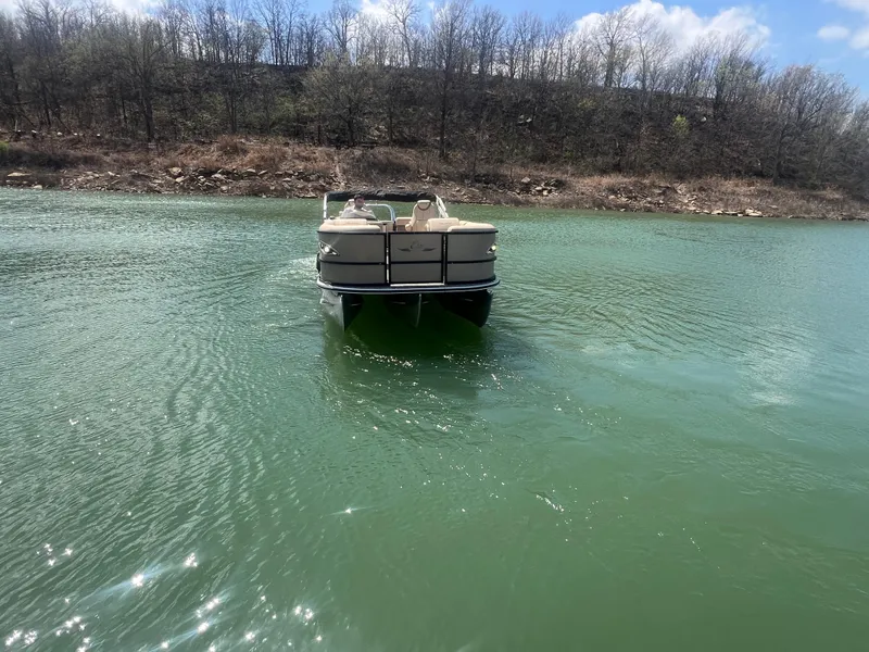 Slide: The Image of 2019 Bentley Pontoons 223 on a serene lake with wooded shoreline. - 26