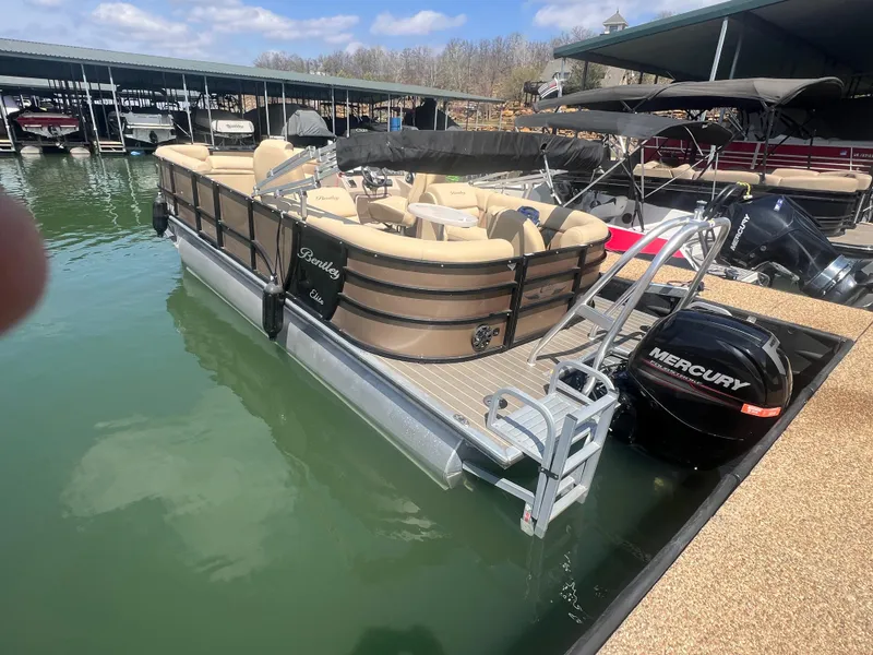 Slide: The Image of 2019 Bentley Pontoons 223 boat docked with Mercury engine, beige seating, and ladder. - 5