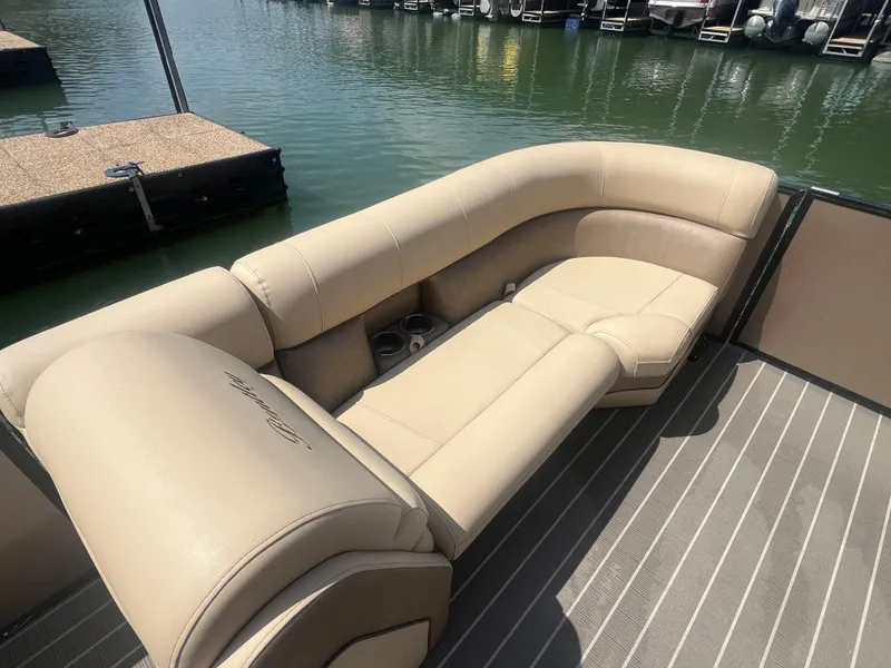 Slide: The Image of 2019 Bentley Pontoons 223 with beige seating, docked on calm water. - 8