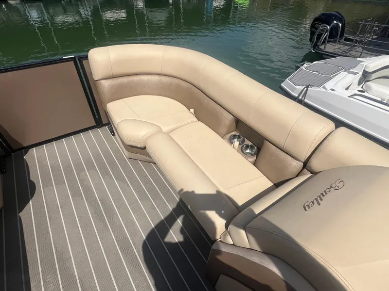 Slide: The Image of 2019 Bentley Pontoons 223 interior with beige seating and striped flooring. - 9
