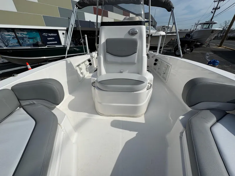 Slide: The Image of 2023 NauticStar 191 Hybrid boat interior with gray seating and center console. - 10