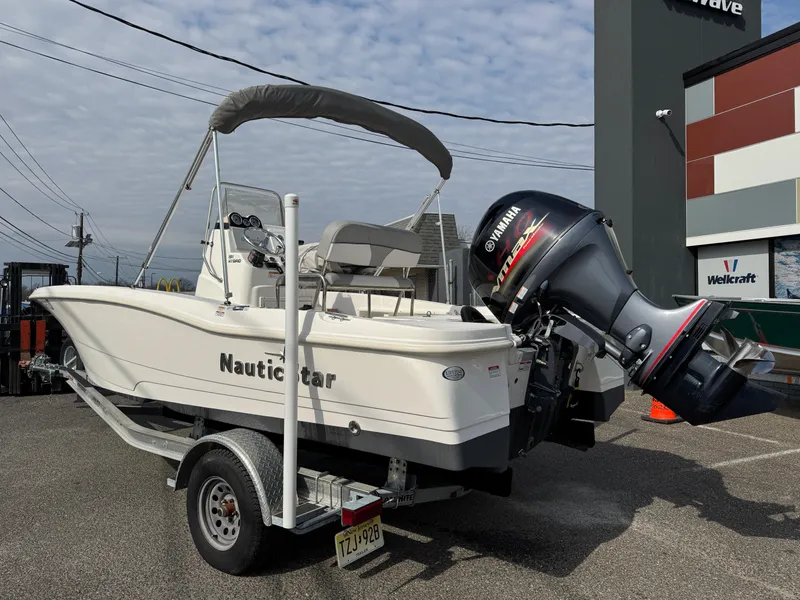 Slide: The Image of 2023 NauticStar 191 Hybrid boat on trailer with Yamaha outboard motor. - 3