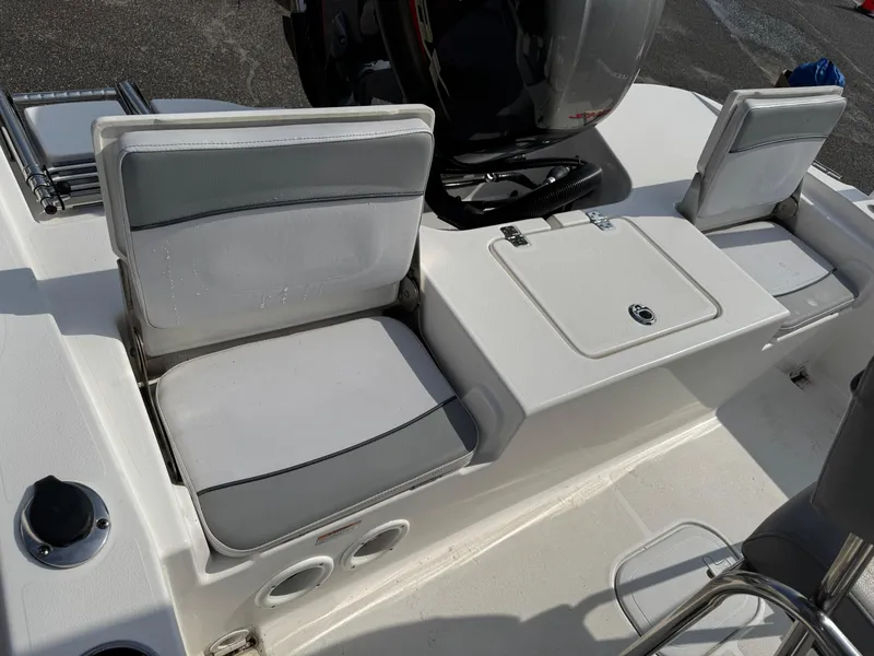 Slide: The Image of 2023 NauticStar 191 Hybrid boat interior with cushioned seating and storage compartments. - 6